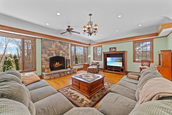 Chandelier, Fireplace, Interior, Living room, Recessed Lighting, Stone Walls, Wood Texture Flooring