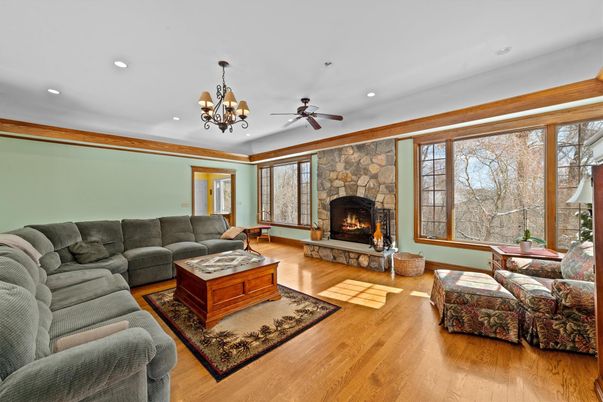 Chandelier, Fireplace, Interior, Living room, Recessed Lighting, Stone Walls, Wood Texture Flooring