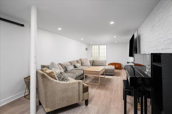 Fireplace, Interior, Living room, Piano, Recessed Lighting, Stone Walls, Wood Texture Flooring