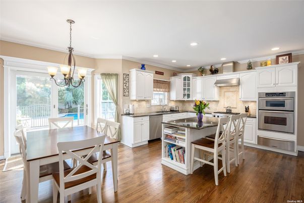 Chandelier, Dining room, Interior, Kitchen, Pendant Lights, Recessed Lighting, Stainless Steel Appliances, Wood Texture Flooring