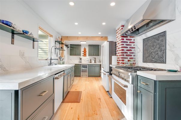 Interior, Kitchen, Marble Walls, Recessed Lighting, Stainless Steel Appliances, Wood Texture Flooring