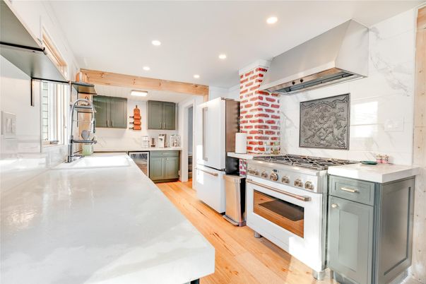 Interior, Kitchen, Marble Walls, Recessed Lighting, Stainless Steel Appliances, Wood Texture Flooring