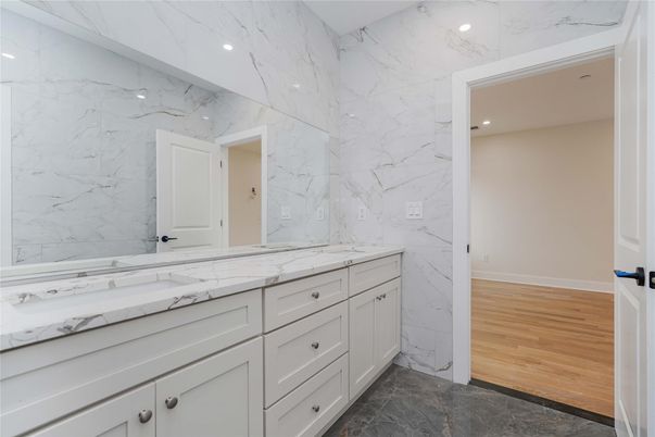 Bathroom, Dual Sink Vanities, Interior, Marble Walls, Recessed Lighting, Wood Texture Flooring