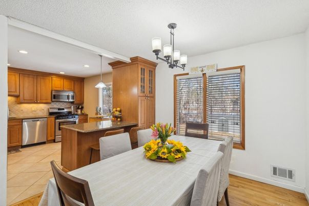 Chandelier, Dining room, Interior, Kitchen, Pendant Lights, Recessed Lighting, Stainless Steel Appliances, Wood Texture Flooring