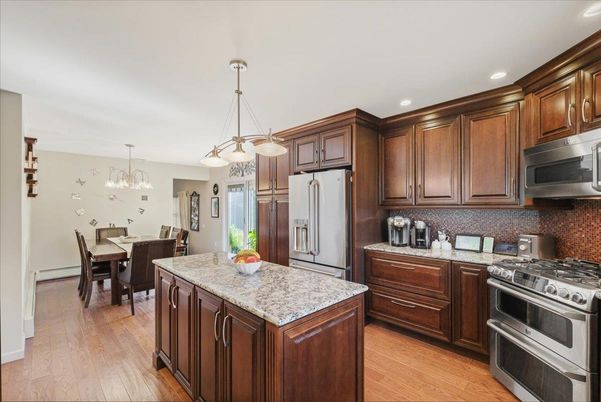 Chandelier, Dining room, Interior, Kitchen, Pendant Lights, Recessed Lighting, Stainless Steel Appliances, Wood Texture Flooring