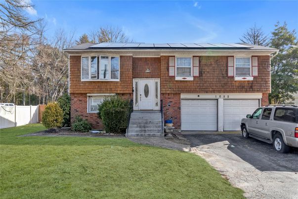 Attached, Exterior, Facade, Brick Facade, Solar Panels, Raised Ranch