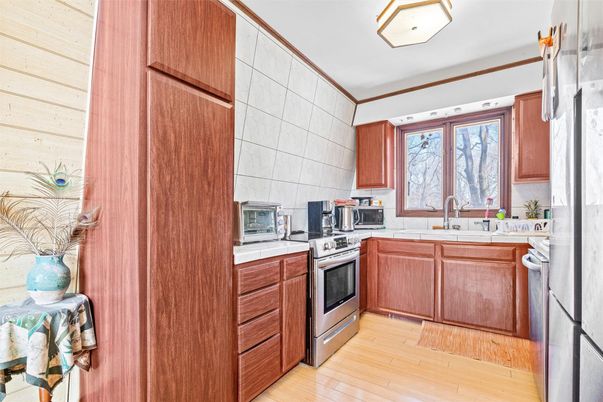 Interior, Kitchen, Stainless Steel Appliances, Tile Countertops, Wood Texture Flooring