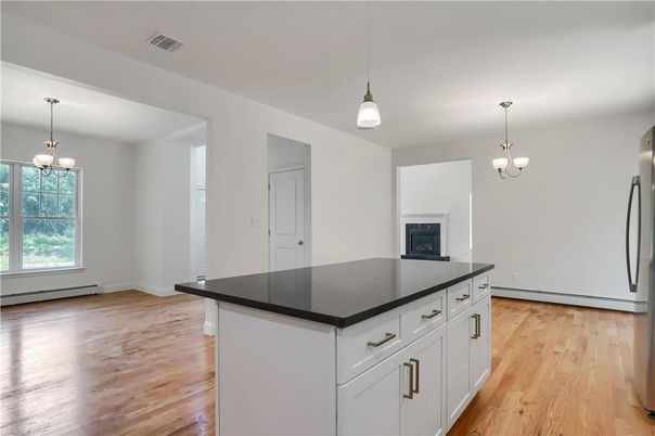 Chandelier, Empty room, Fireplace, Interior, Kitchen, Pendant Lights, Wood Texture Flooring