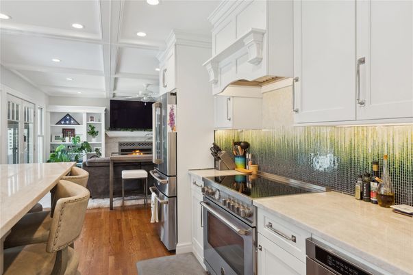 Dining room, Fireplace, Interior, Kitchen, Recessed Lighting, Stainless Steel Appliances, Wood Texture Flooring