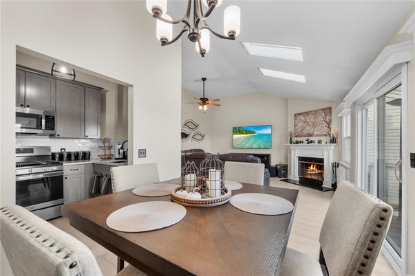 Chandelier, Dining room, Fireplace, Interior, Kitchen, Stainless Steel Appliances, Wood Texture Flooring