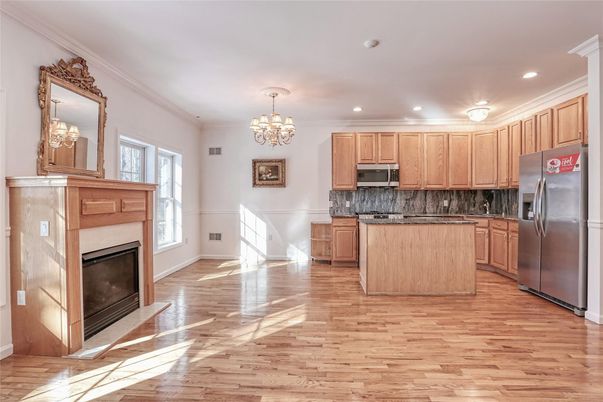 Chandelier, Fireplace, Interior, Kitchen, Recessed Lighting, Stainless Steel Appliances, Wood Texture Flooring