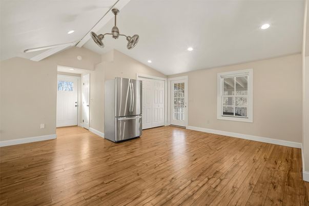 Empty room, Interior, Kitchen, Pendant Lights, Recessed Lighting, Stainless Steel Appliances, Wood Texture Flooring