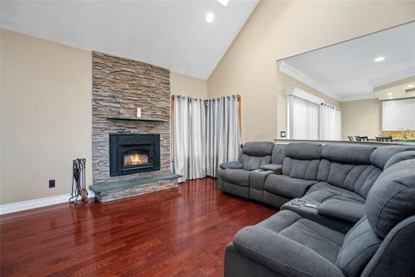 Fireplace, Interior, Living room, Recessed Lighting, Stone Walls, Wood Texture Flooring