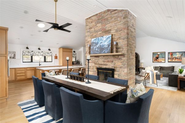 Dining room, Fireplace, Interior, Living room, Recessed Lighting, Stone Walls, Wood Texture Flooring