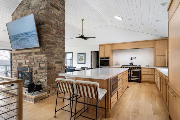 Fireplace, Interior, Kitchen, Recessed Lighting, Stainless Steel Appliances, Stone Walls, Wood Texture Flooring