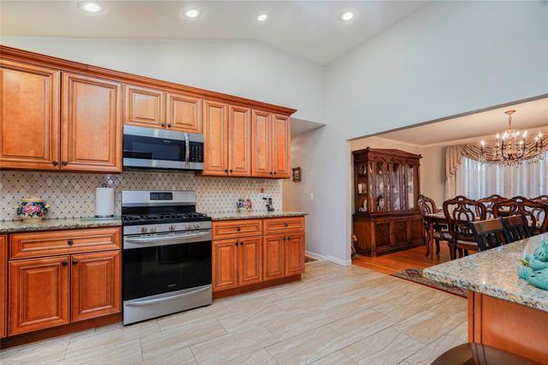 Chandelier, Dining room, Interior, Kitchen, Recessed Lighting, Stainless Steel Appliances, Wood Texture Flooring