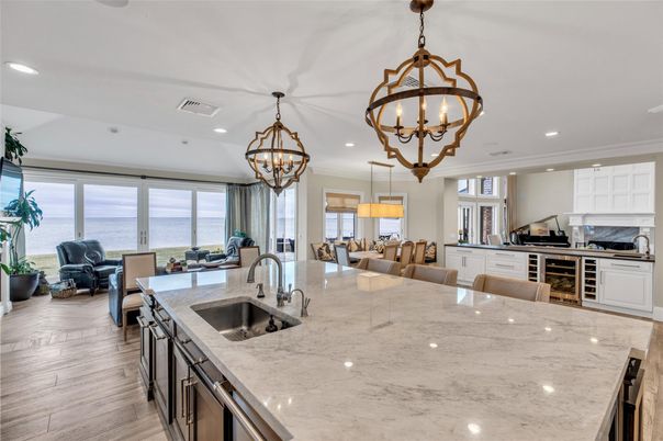 Chandelier, Dining room, Interior, Kitchen, Living room, Pendant Lights, Recessed Lighting, Stainless Steel Appliances, Water, Wood Texture Flooring