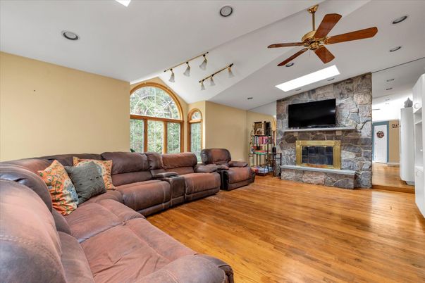 Fireplace, Interior, Living room, Recessed Lighting, Stone Walls, Wood Texture Flooring