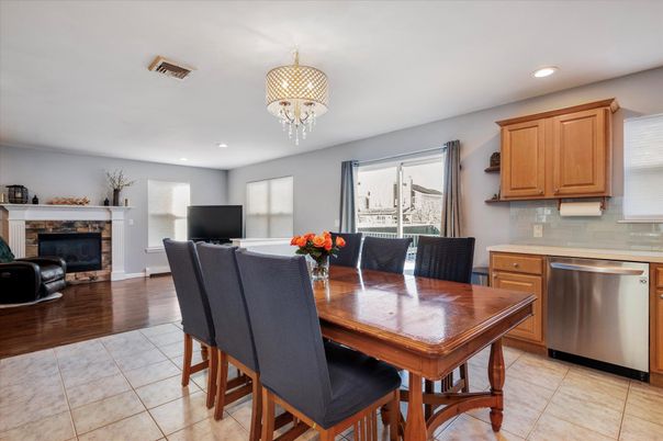 Chandelier, Dining room, Fireplace, Interior, Kitchen, Living room, Recessed Lighting, Stainless Steel Appliances, Wood Texture Flooring