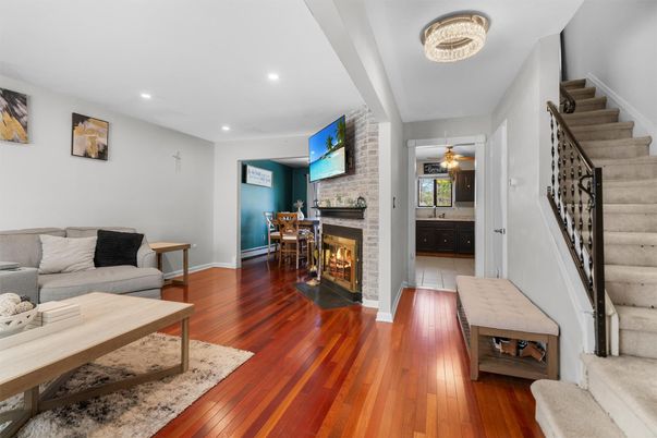 Dining room, Fireplace, Interior, Living room, Recessed Lighting, Stone Walls, Wood Texture Flooring