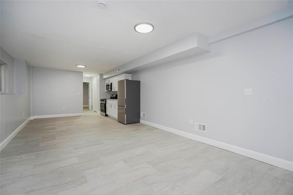 Empty room, Interior, Kitchen, Recessed Lighting, Stainless Steel Appliances, Wood Texture Flooring