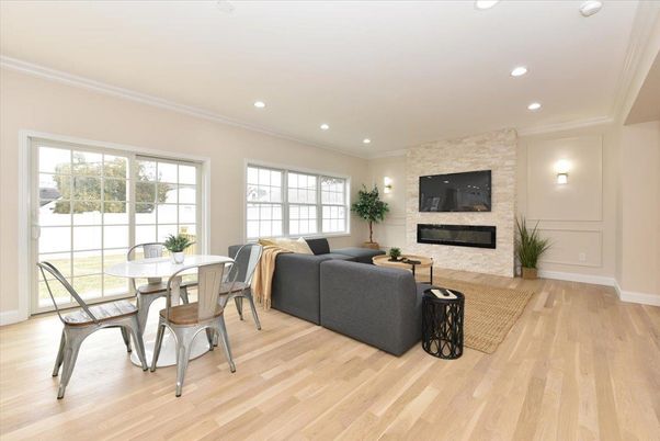 Dining room, Fireplace, Interior, Living room, Recessed Lighting, Stone Walls, Wood Texture Flooring