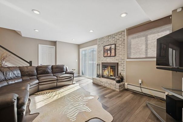 Fireplace, Interior, Living room, Recessed Lighting, Stone Walls, Wood Texture Flooring