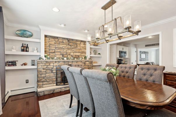 Dining room, Fireplace, Interior, Pendant Lights, Recessed Lighting, Stone Walls, Wood Texture Flooring