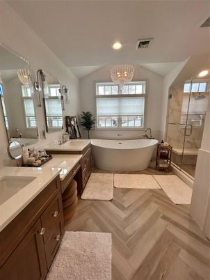 Bathroom, Chandelier, Dual Sink Vanities, Free Standing Baths, Glass Shower, Interior, Recessed Lighting, Wood Texture Flooring