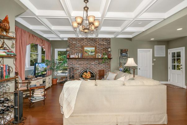 Chandelier, Fireplace, Interior, Living room, Recessed Lighting, Stone Walls, Wood Texture Flooring