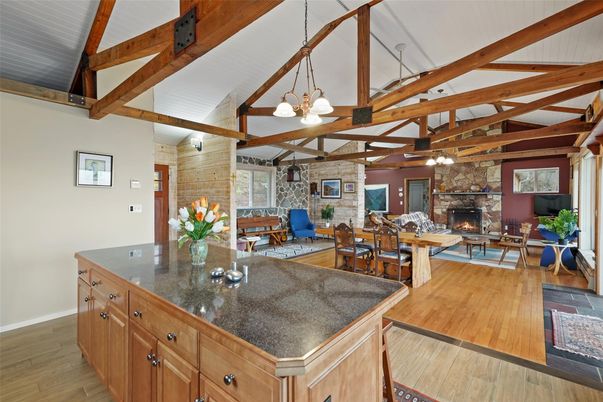 Chandelier, Dining room, Fireplace, Interior, Kitchen, Living room, Pendant Lights, Stone Walls, Wooden Beams, Wood Texture Flooring