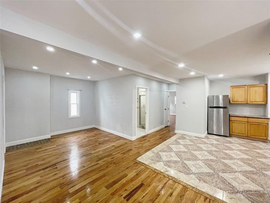 Empty room, Interior, Kitchen, Recessed Lighting, Stainless Steel Appliances, Wood Texture Flooring