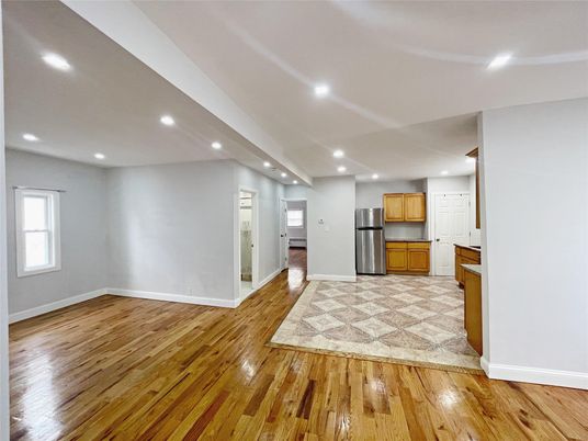 Empty room, Interior, Kitchen, Recessed Lighting, Stainless Steel Appliances, Wood Texture Flooring