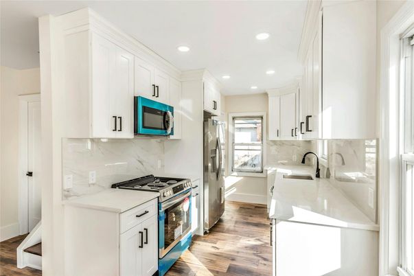 Interior, Kitchen, Marble Walls, Recessed Lighting, Stainless Steel Appliances, Wood Texture Flooring