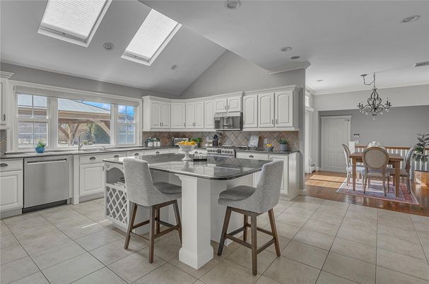 Chandelier, Dining room, Interior, Kitchen, Recessed Lighting, Stainless Steel Appliances, Wood Texture Flooring