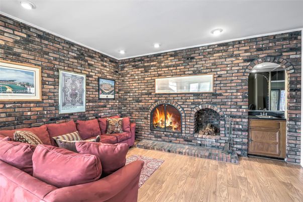 Fireplace, Interior, Living room, Recessed Lighting, Stone Walls, Wood Texture Flooring