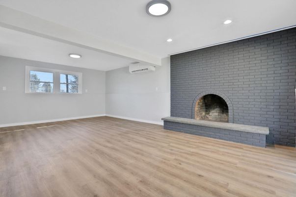 Empty room, Fireplace, Interior, Recessed Lighting, Stone Walls, Wood Texture Flooring