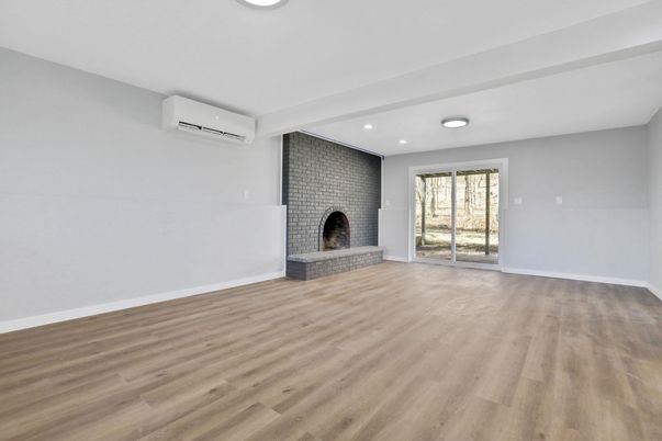 Empty room, Fireplace, Interior, Recessed Lighting, Stone Walls, Wood Texture Flooring