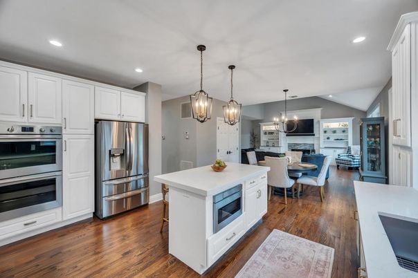 Chandelier, Dining room, Fireplace, Interior, Kitchen, Living room, Pendant Lights, Recessed Lighting, Stainless Steel Appliances, Wood Texture Flooring