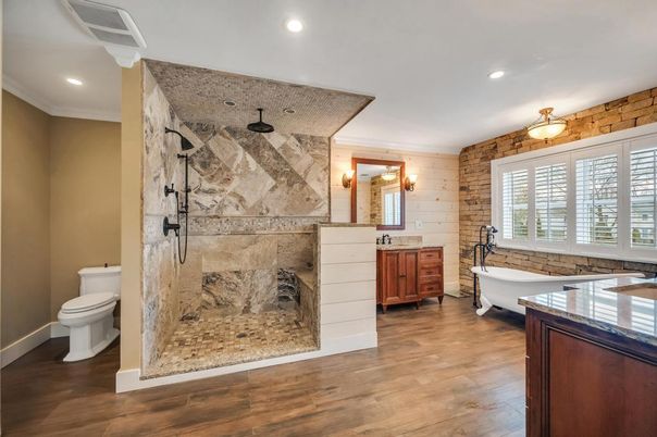 Bathroom, Free Standing Baths, Interior, Marble Walls, Recessed Lighting, Stone Walls, Wood Texture Flooring