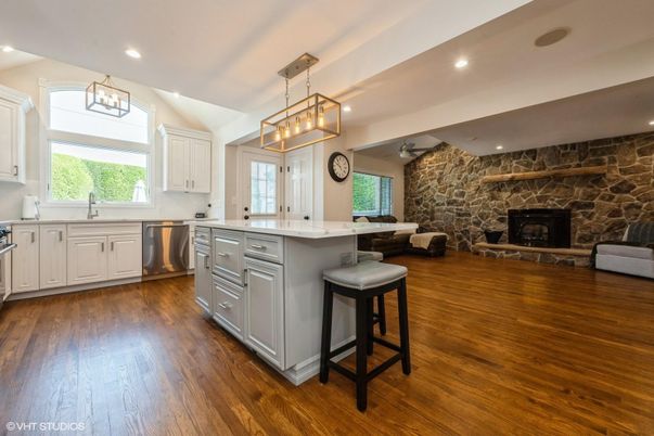 Fireplace, Interior, Kitchen, Pendant Lights, Recessed Lighting, Stainless Steel Appliances, Stone Walls, Wood Texture Flooring