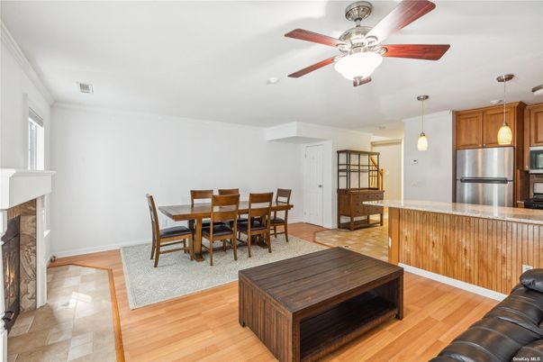 Dining room, Fireplace, Interior, Kitchen, Pendant Lights, Stainless Steel Appliances, Wood Texture Flooring