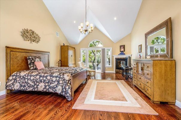 Bedroom, Chandelier, Fireplace, Interior, Recessed Lighting, Wood Texture Flooring