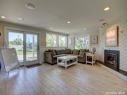 Fireplace, Interior, Living room, Recessed Lighting, Stone Walls, Wood Texture Flooring