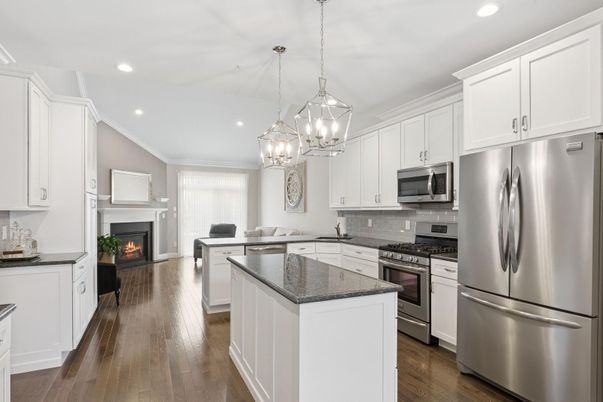 Fireplace, Interior, Kitchen, Living room, Pendant Lights, Recessed Lighting, Stainless Steel Appliances, Wood Texture Flooring