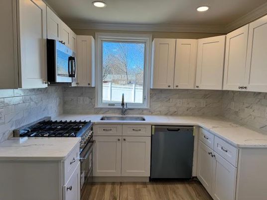 Interior, Kitchen, Marble Walls, Recessed Lighting, Stainless Steel Appliances, Wood Texture Flooring