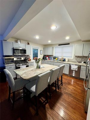 Dining room, Interior, Kitchen, Recessed Lighting, Stainless Steel Appliances, Wood Texture Flooring