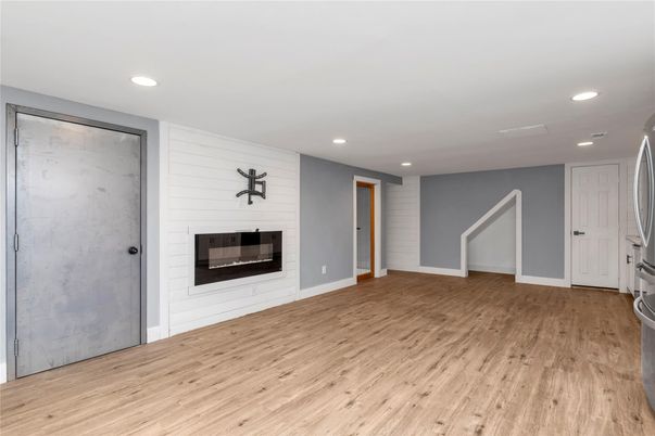Empty room, Fireplace, Interior, Marble Walls, Recessed Lighting, Wood Texture Flooring