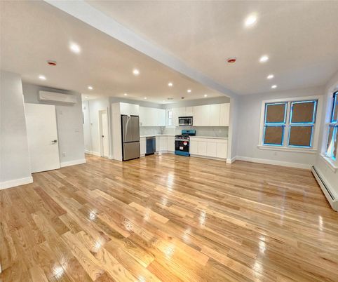 Empty room, Interior, Kitchen, Recessed Lighting, Stainless Steel Appliances, Wood Texture Flooring