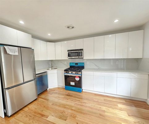 Interior, Kitchen, Marble Walls, Recessed Lighting, Stainless Steel Appliances, Wood Texture Flooring